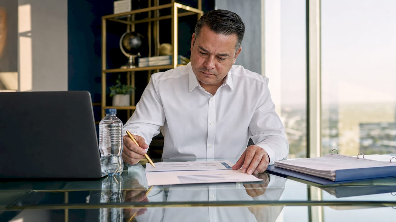 Small business owner reviewing financial papers