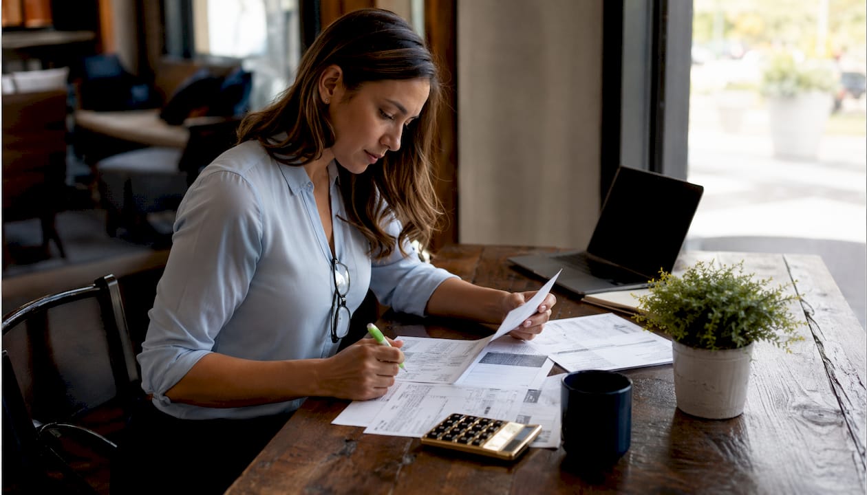 Bookkeeper assessing financial documents in plumber office