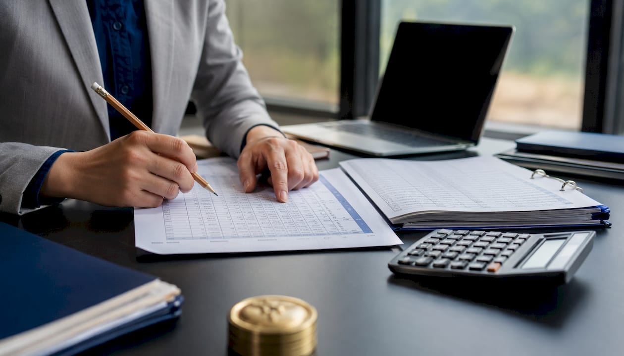Close-up hands reconciling financial statements
