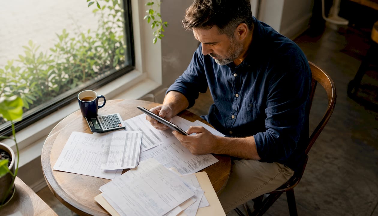 HVAC business owner reviewing financials on tablet