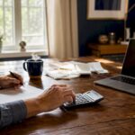 Small business owner calculating expenses