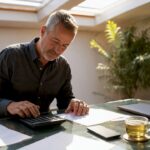Business owner calculating finances at desk