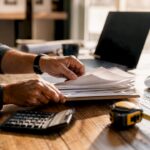 Hands tagging invoices in contractor office