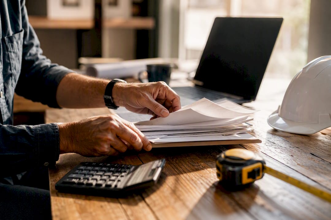 Hands tagging invoices in contractor office