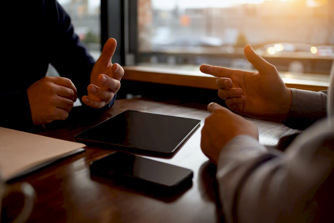 Hands with devices showing insurance options